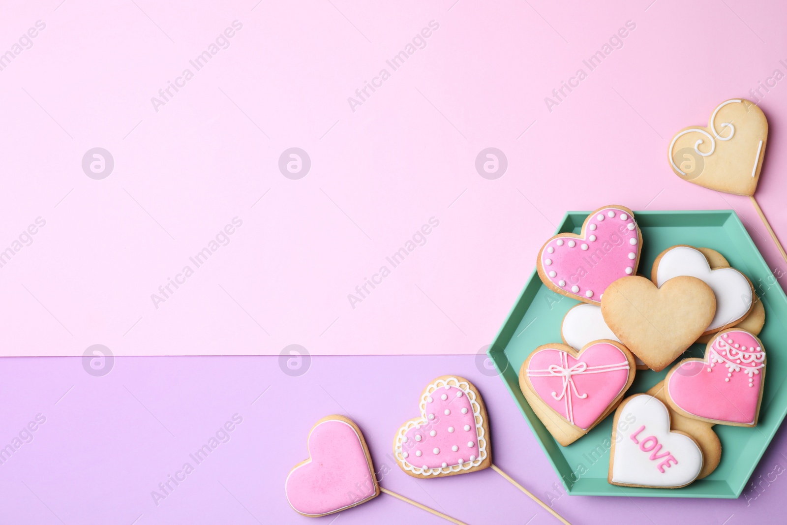 Photo of Flat lay composition with heart shaped cookies on color background. Space for text