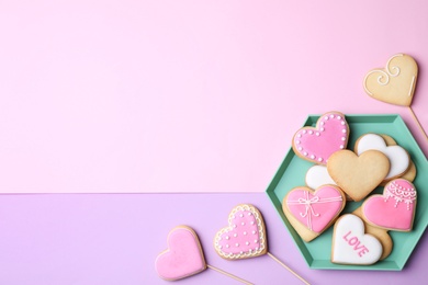Photo of Flat lay composition with heart shaped cookies on color background. Space for text