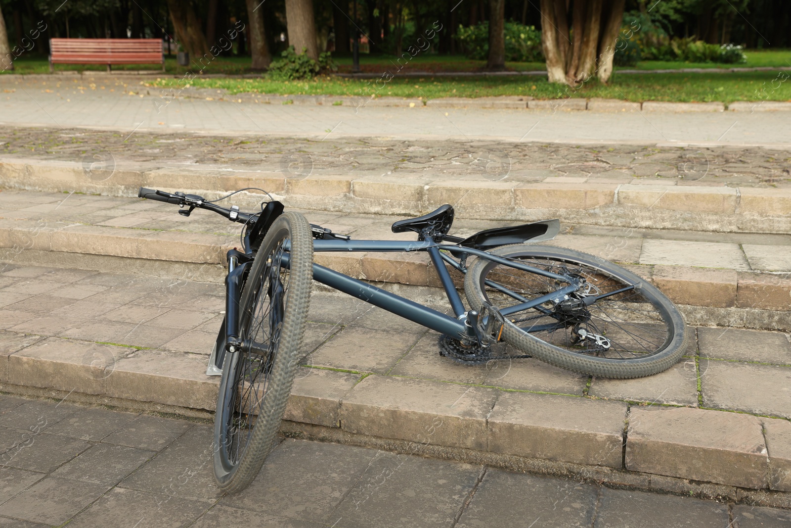 Photo of Fallen beautiful modern bicycle on steps outdoors