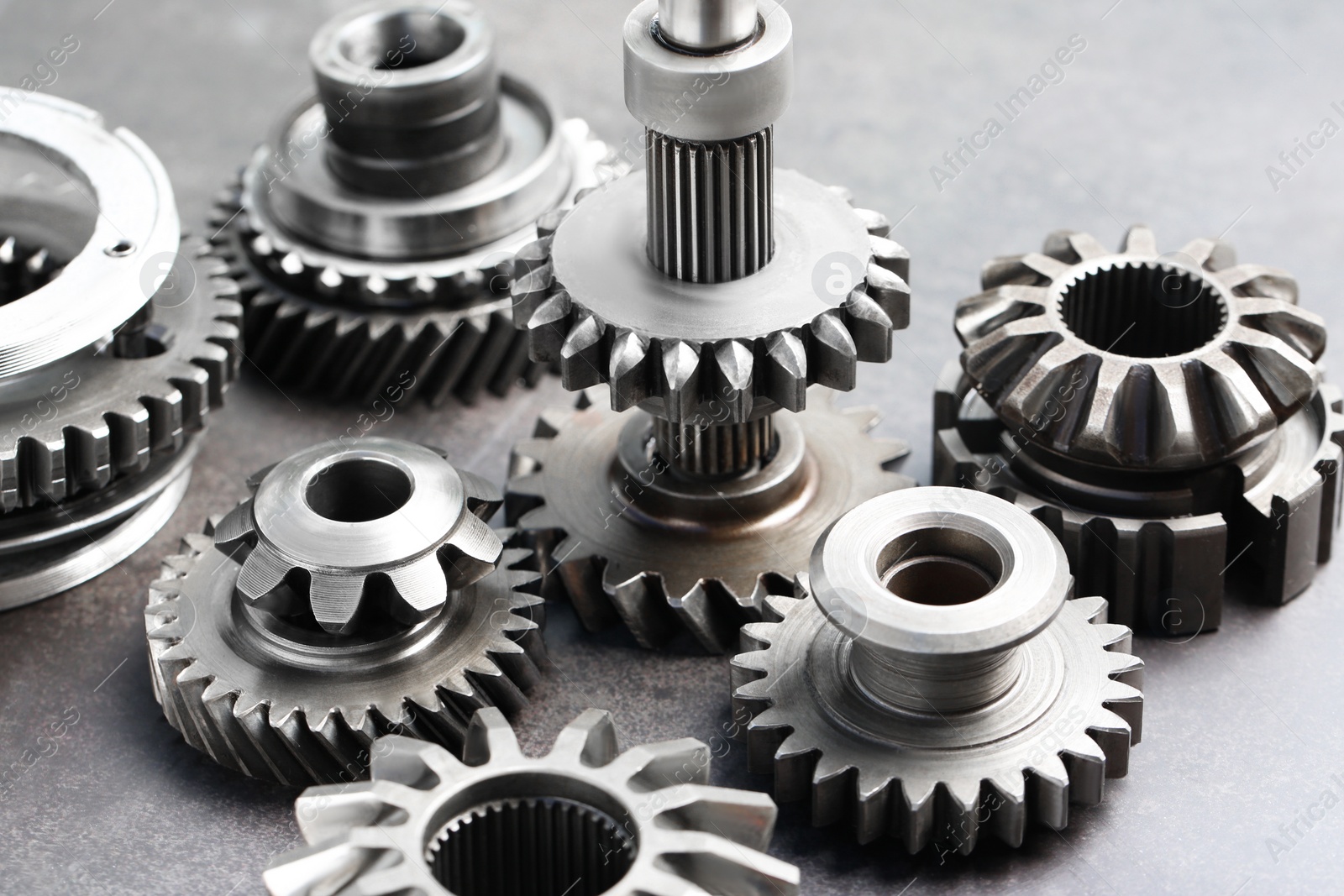 Photo of Different stainless steel gears on light grey background, closeup