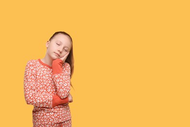 Photo of Sleepy girl on orange background, space for text. Insomnia problem