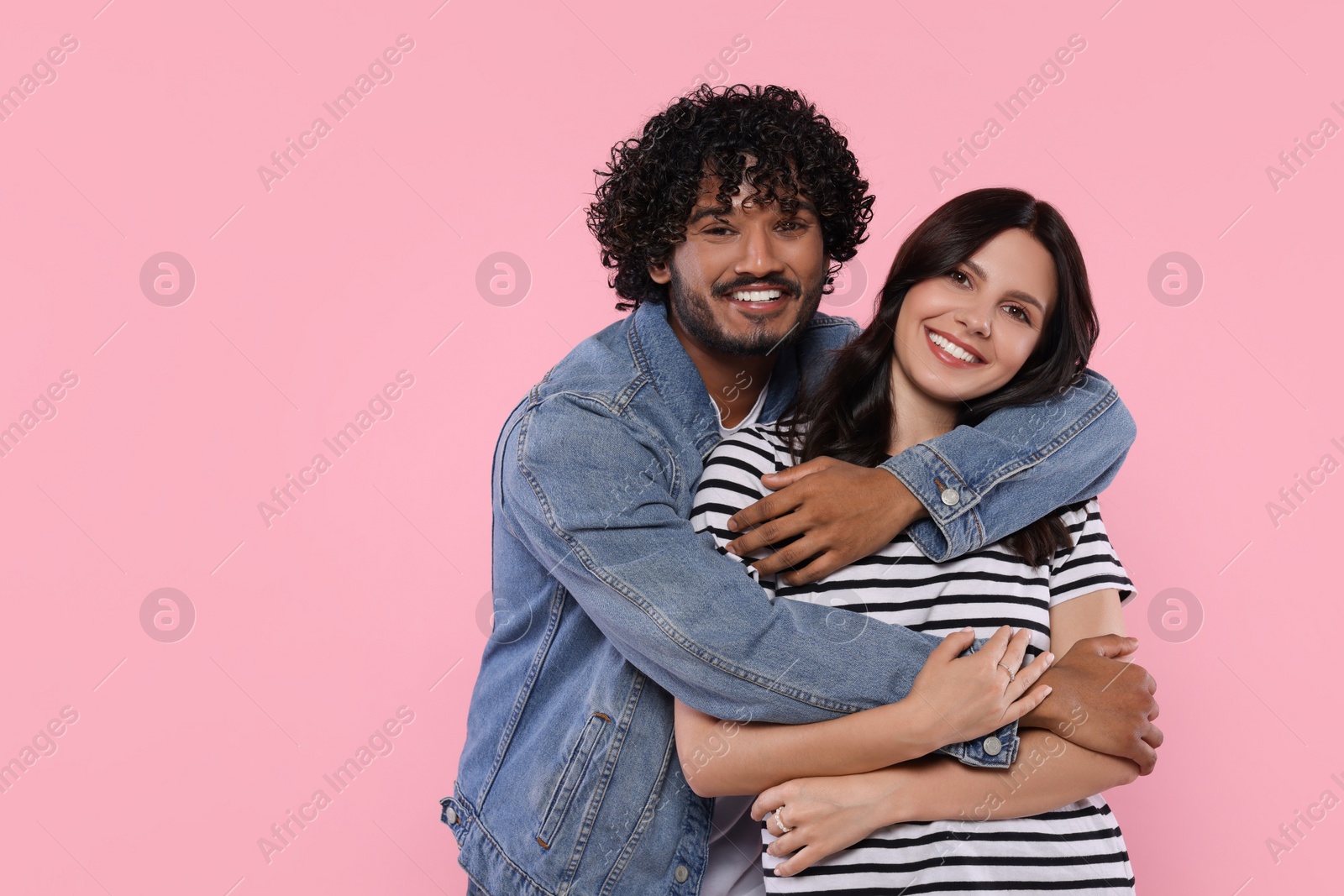 Photo of International dating. Lovely couple hugging on pink background, space for text