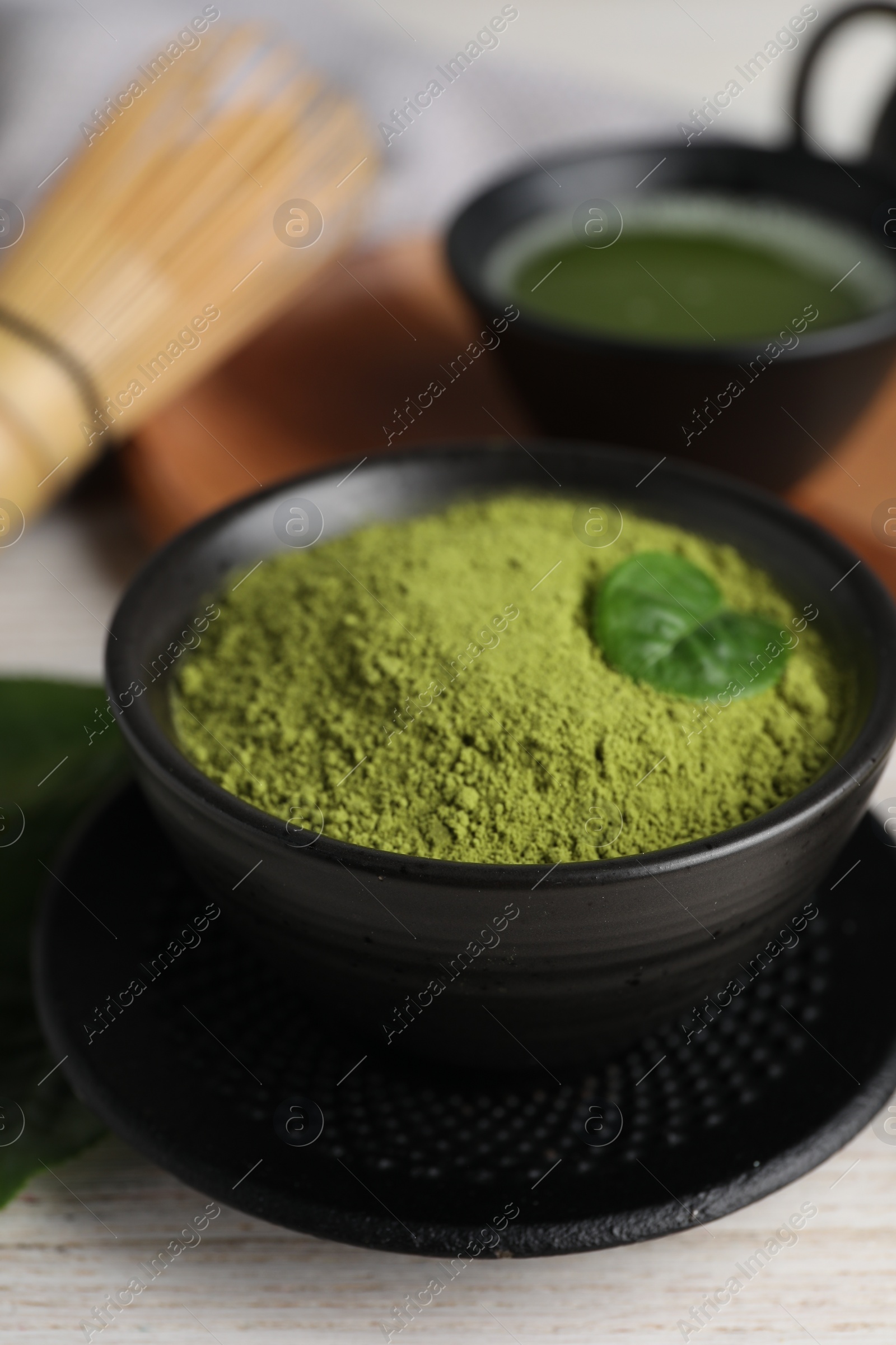 Photo of Green matcha powder on white table, closeup
