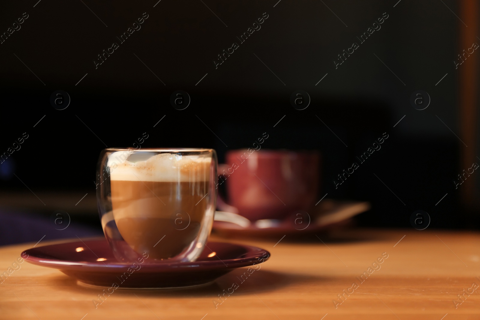 Photo of Aromatic coffee on wooden table in cafe. Space for text