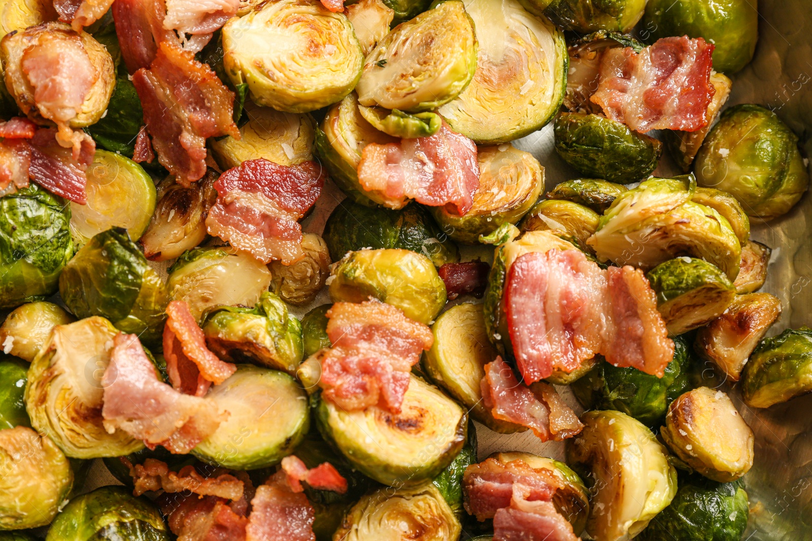 Photo of Delicious roasted Brussels sprouts with bacon as background, closeup