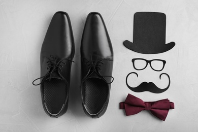Photo of Flat lay composition with shoes, bow tie and paper decor on gray background. Happy Father's Day