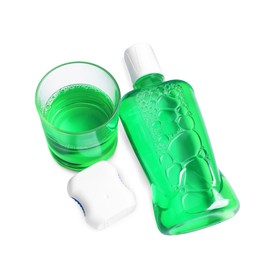 Photo of Fresh mouthwash, bottle, glass and dental floss isolated on white, above view