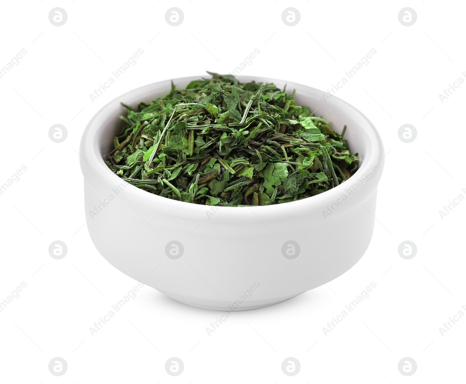 Photo of Bowl of dried parsley isolated on white