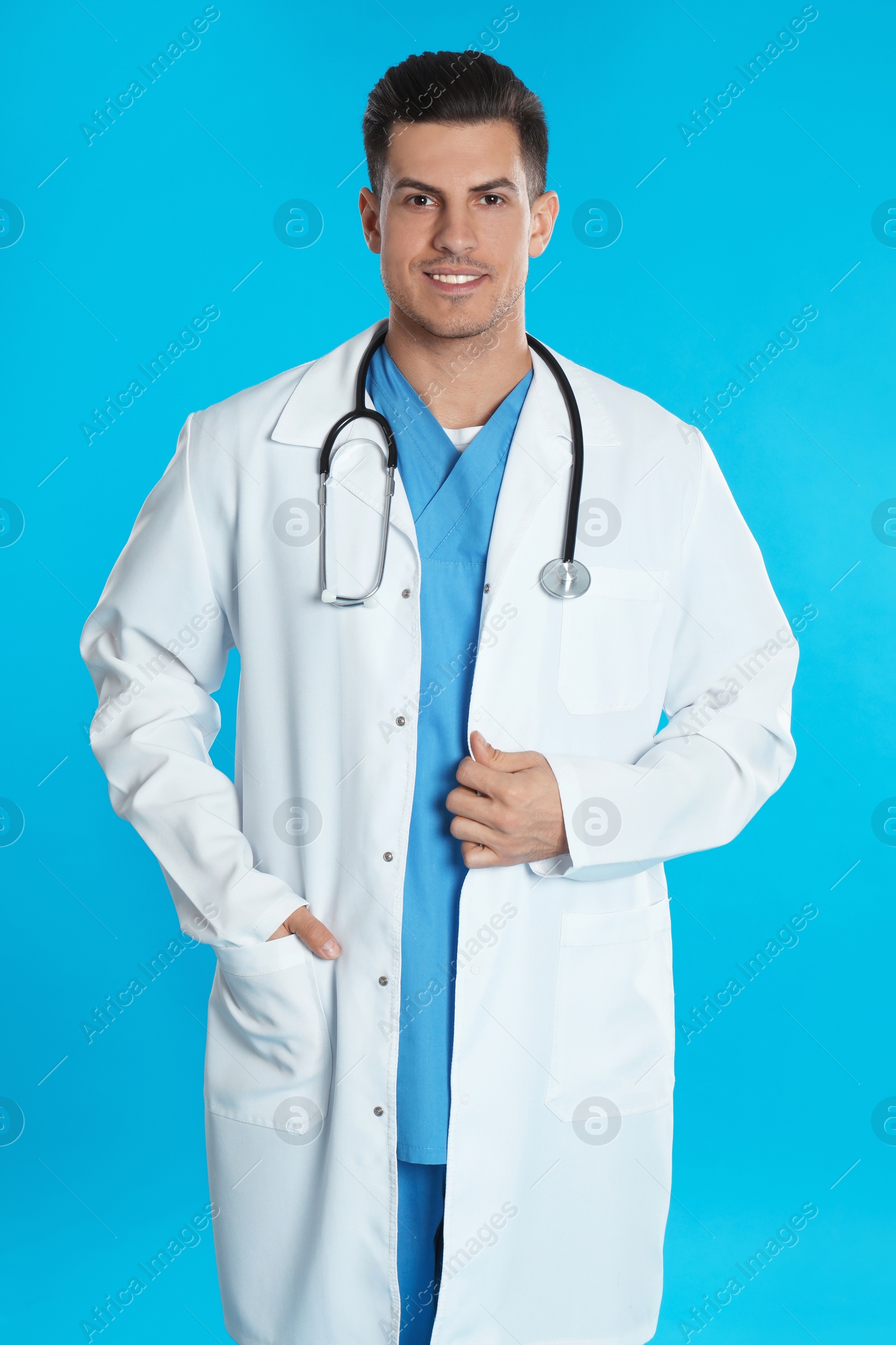 Photo of Portrait of doctor with stethoscope on blue background