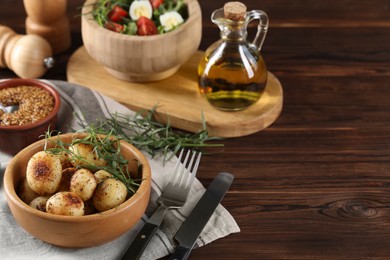 Photo of Delicious grilled potatoes with tarragon, mustard and salad on wooden table. Space for text