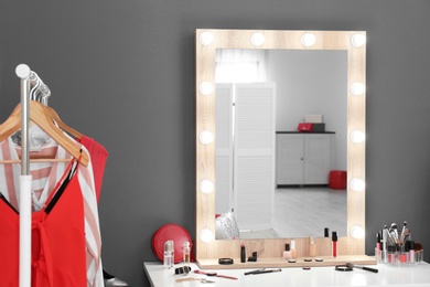 Stylish room with dressing table, mirror and wardrobe rack