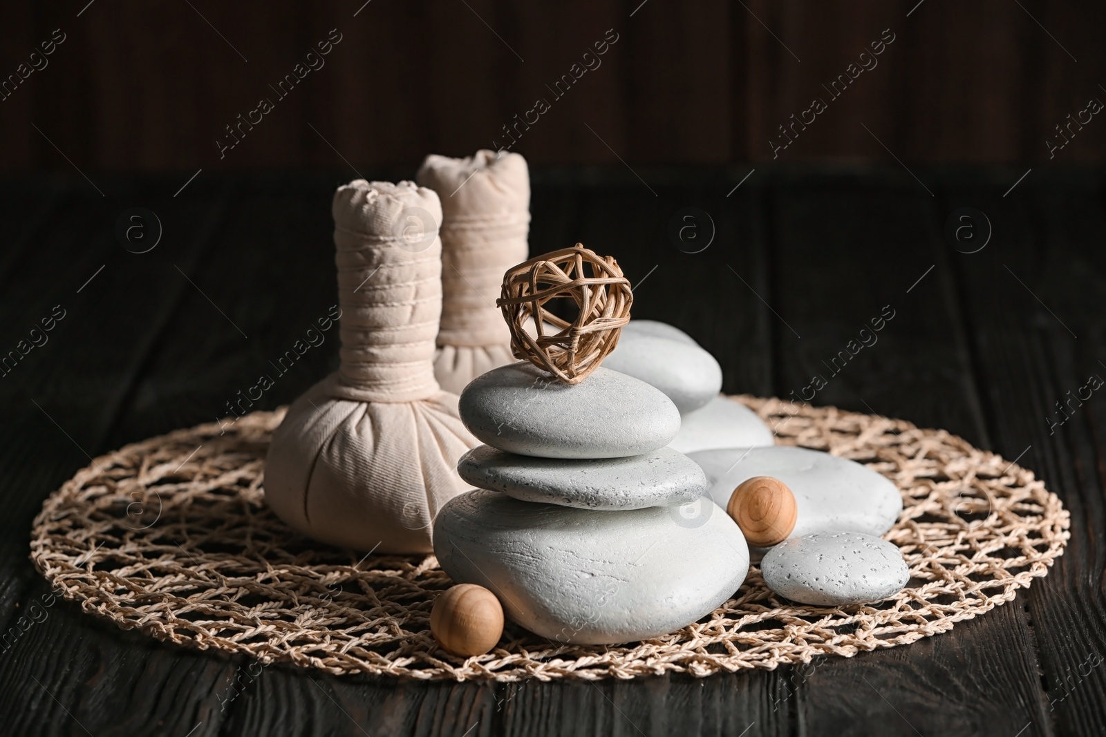 Photo of Composition with spa stones on wooden table