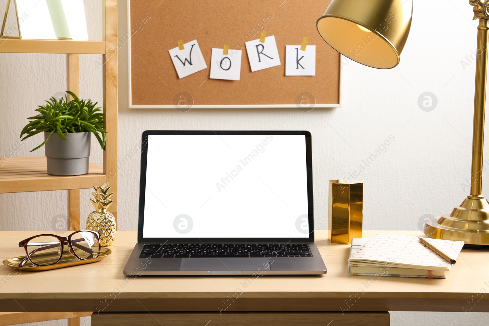 Photo of Stylish workplace with different golden accessories indoors. Idea for interior design