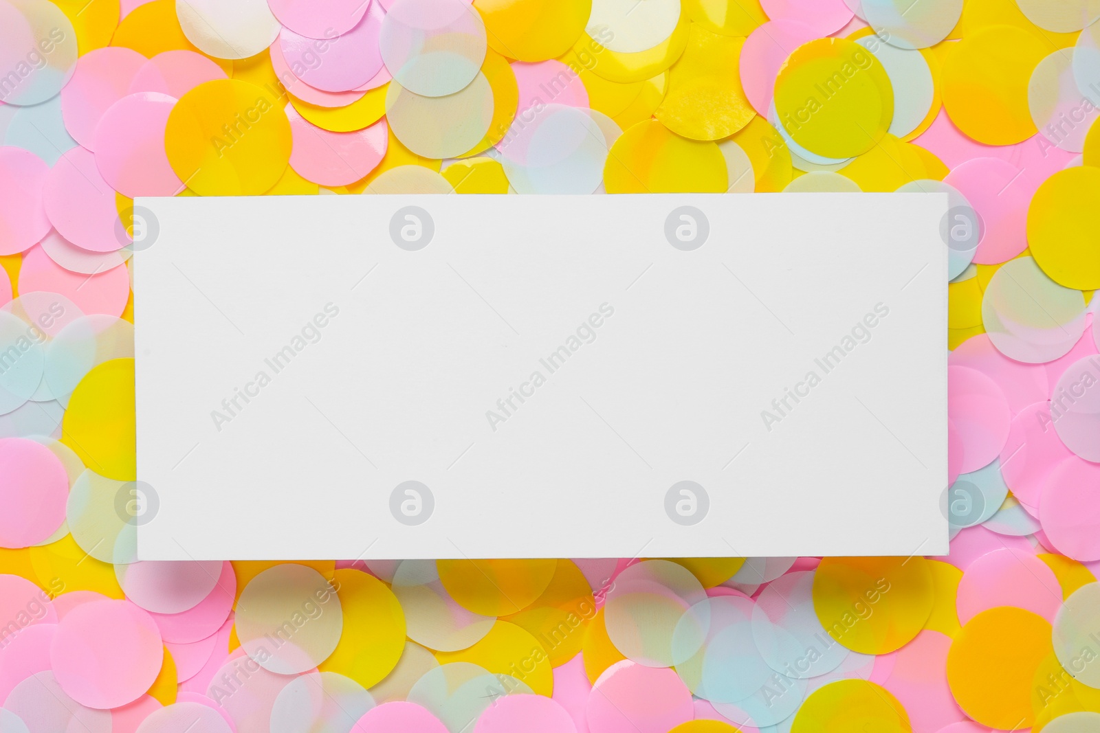 Photo of Card on bright confetti, top view. Space for text