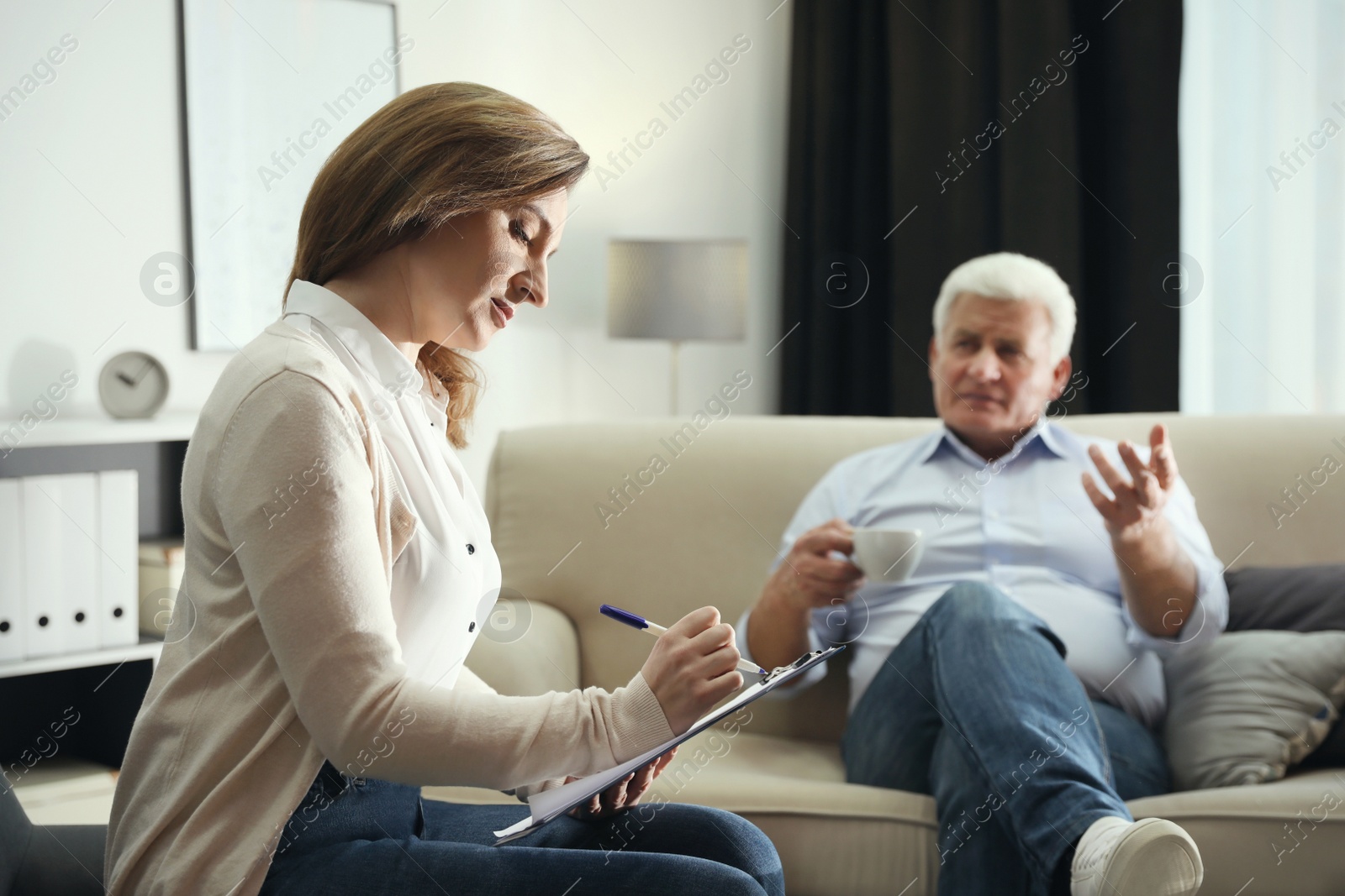 Photo of Professional psychotherapist working with patient in office