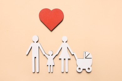 Figures of family and heart on beige background, top view. Insurance concept