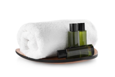 Composition with mini bottles of cosmetic products and towel on white background