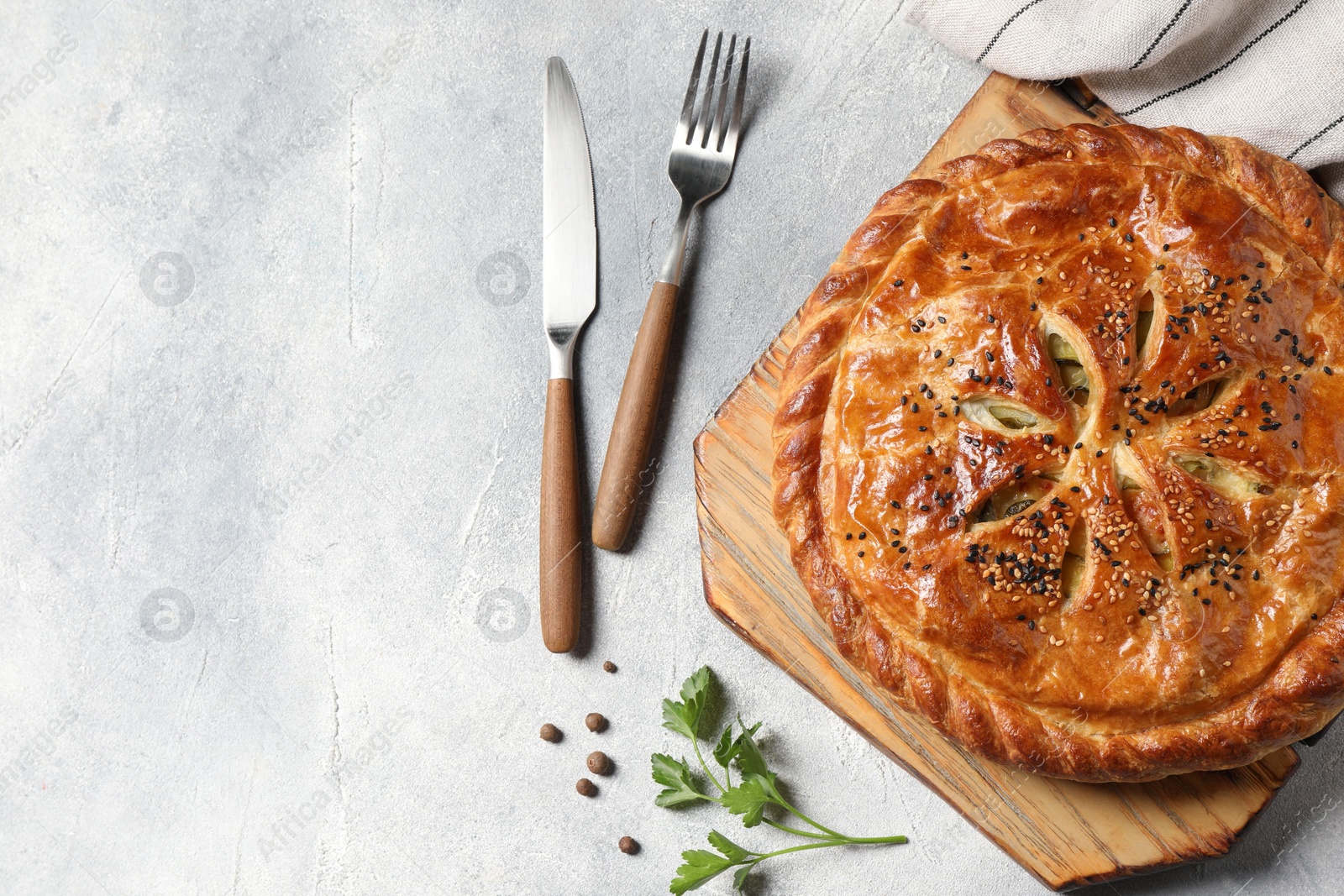 Photo of Tasty homemade pie served on light grey table, flat lay. Space for text