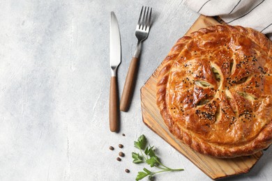 Photo of Tasty homemade pie served on light grey table, flat lay. Space for text