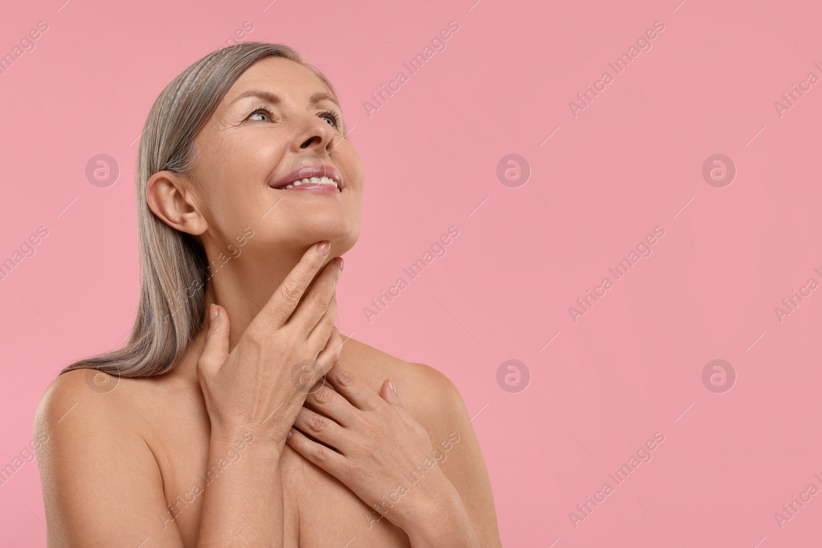 Photo of Beautiful woman with healthy skin on pink background, space for text