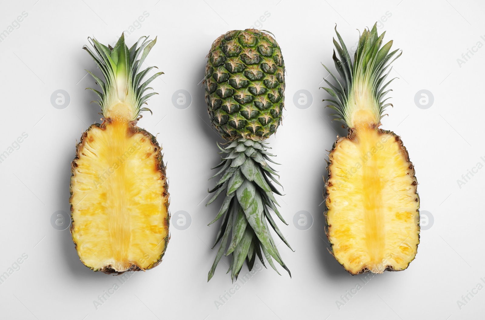 Photo of Tasty ripe pineapples on white background, top view