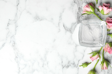 Photo of Flat lay composition with cosmetic gel and beautiful flowers on white marble table. Space for text