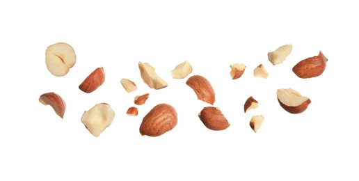 Photo of Pieces of tasty hazelnuts on white background