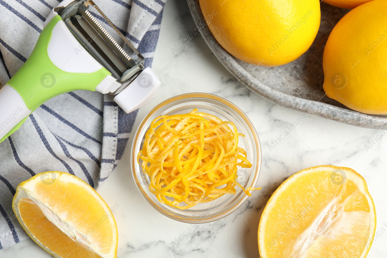 Photo of Lemon zest and fresh fruits on white marble table, flat lay