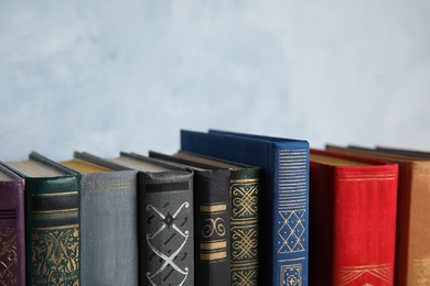 Stack of hardcover books on light blue background