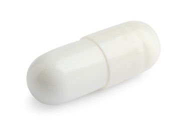 Photo of One pill on white background. Medicinal treatment