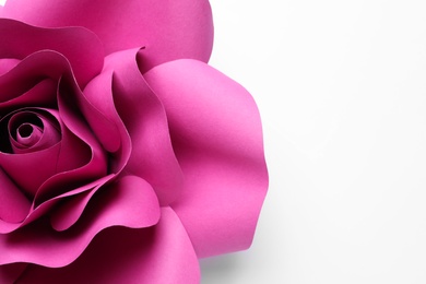 Beautiful pink flower made of paper on white background, top view