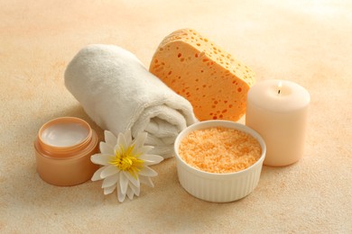 Photo of Composition with bowl of orange sea salt on beige table