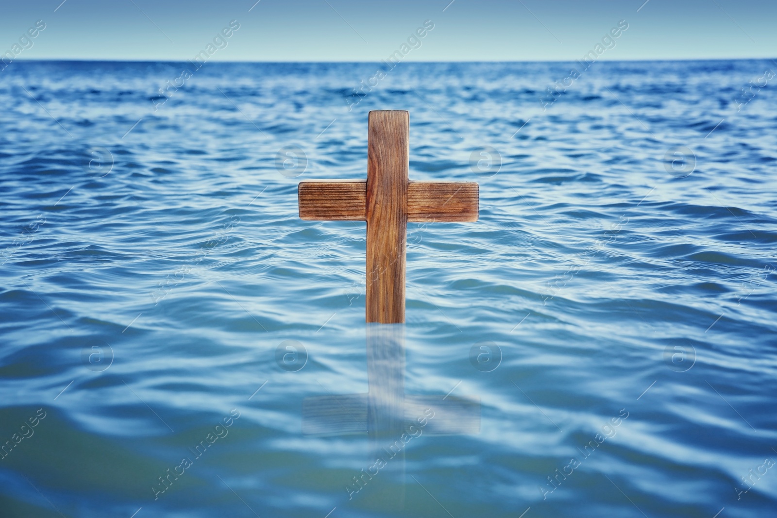 Image of Wooden cross in river for religious ritual known as baptism