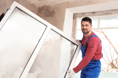 Photo of Workers in uniform with plastic window indoors