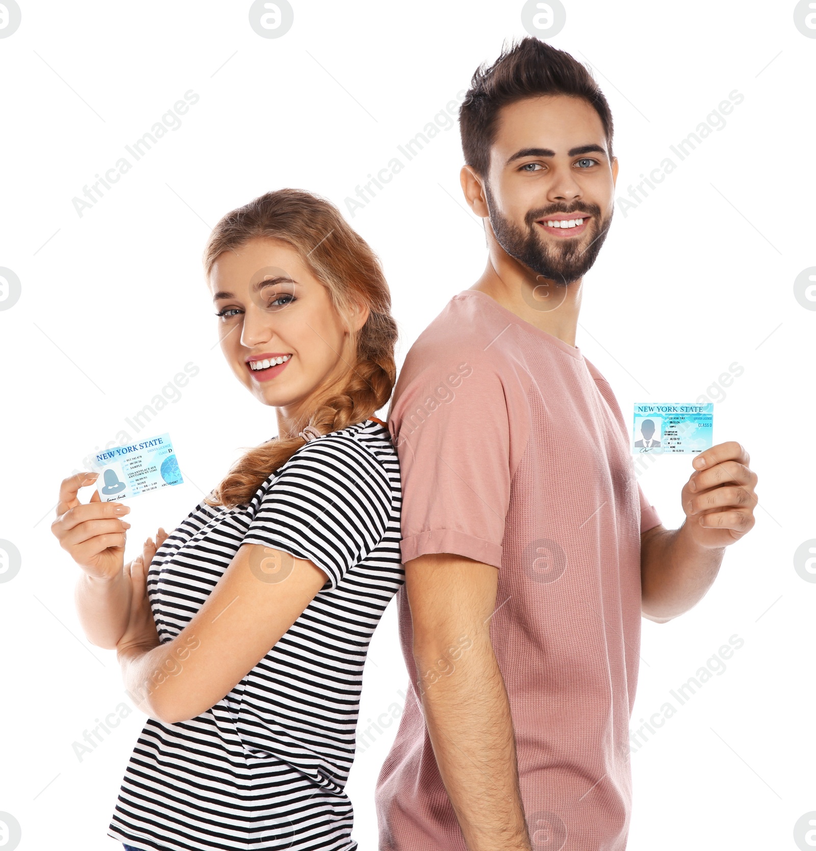 Photo of Happy young people with driving licenses on white background