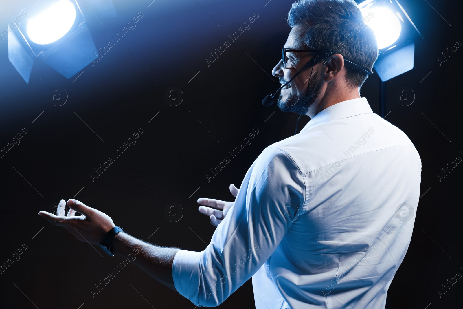 Photo of Motivational speaker with headset performing on stage