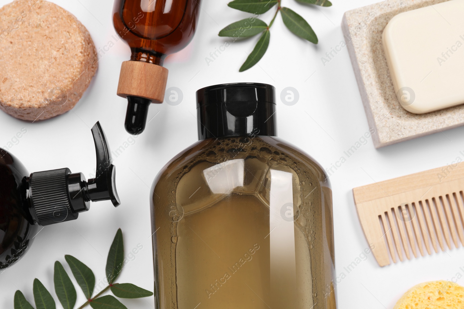 Photo of Flat lay composition with solid shampoo bar and bottles of cosmetic product on white background