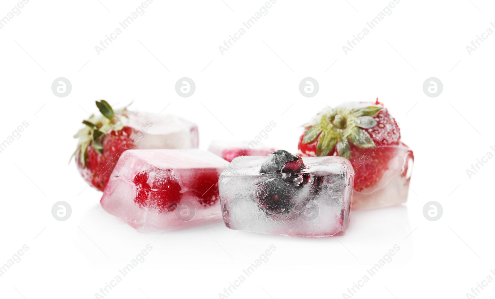 Photo of Fresh berries frozen in ice cubes on white background