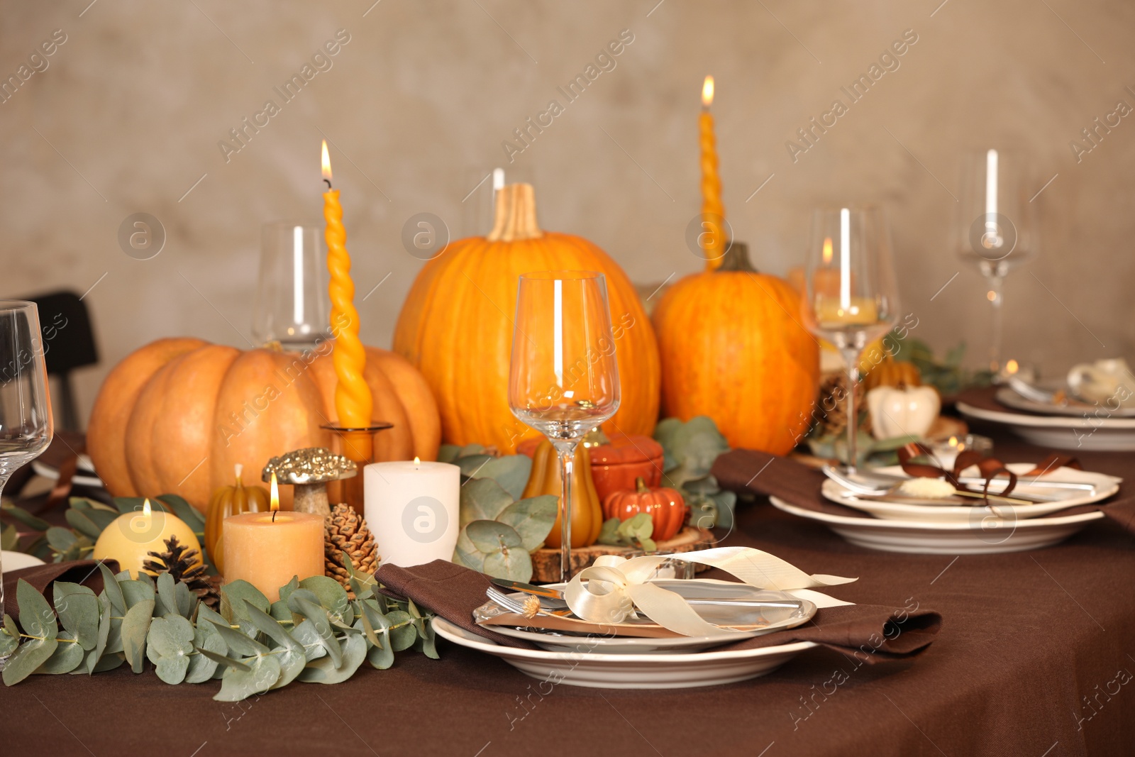 Photo of Beautiful autumn place setting and decor on table in room