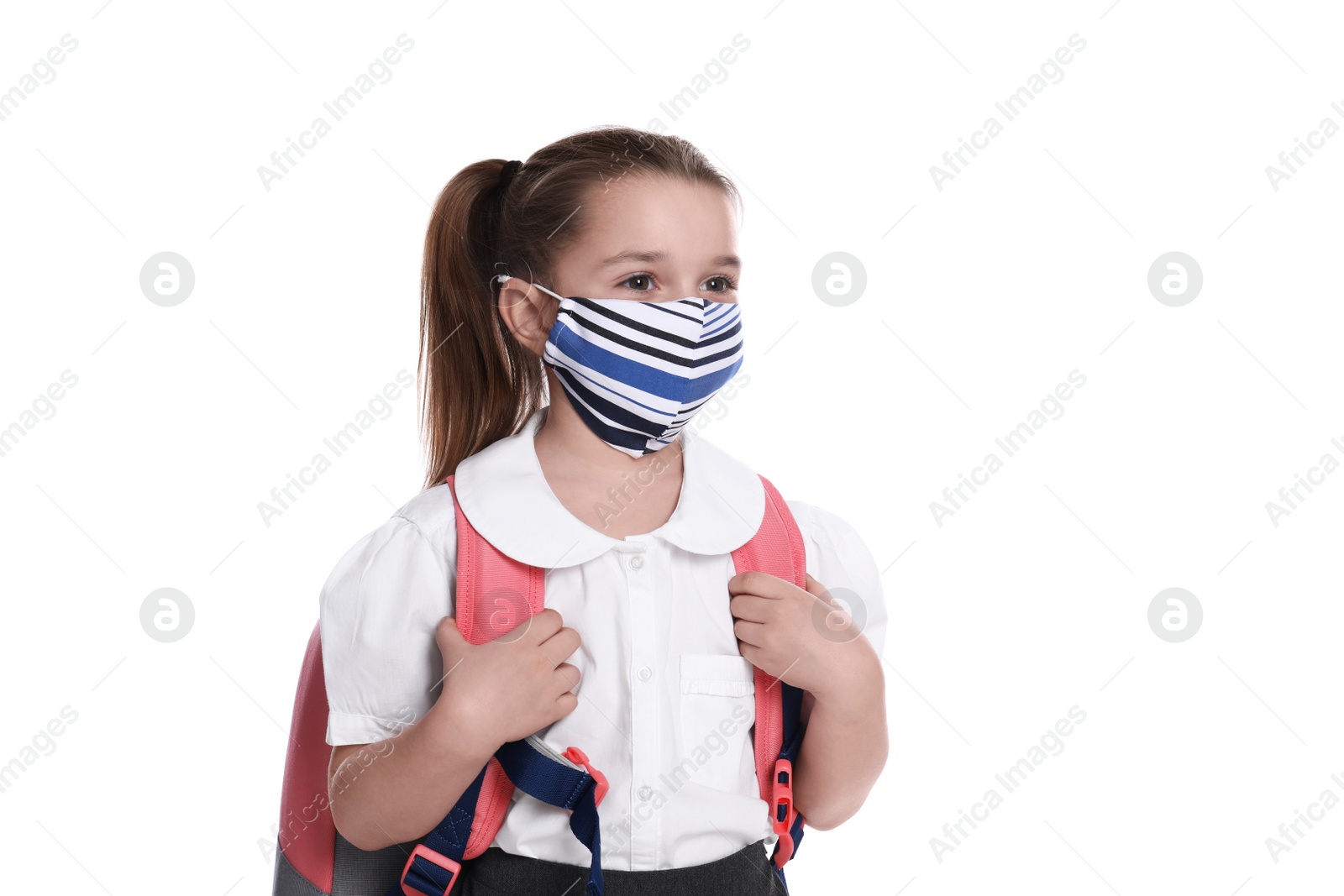 Photo of Little girl wearing protective mask with backpack on white background. Child safety