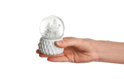 Woman holding beautiful snow globe on white background, closeup