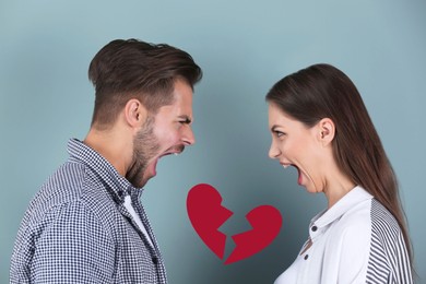 Young couple having argument and illustration of broken heart on color background. Relationship problems