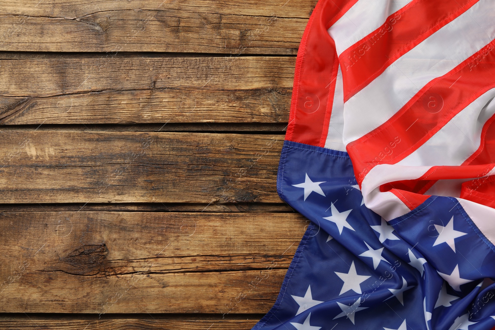 Photo of American flag on wooden table, top view with space for text. Memorial Day