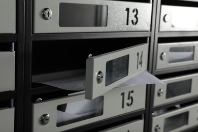 Photo of New mailboxes with keyholes, numbers and receipts, closeup