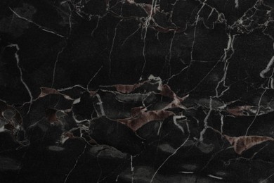 Black marble surface as background, closeup view