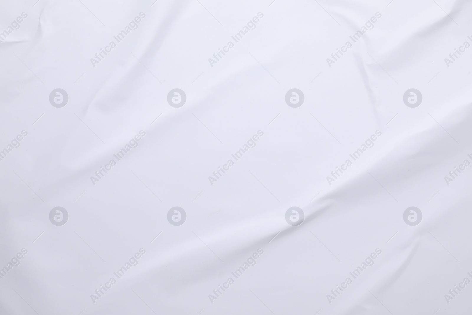 Photo of White crumpled sheet of paper as background, top view. Wall poster