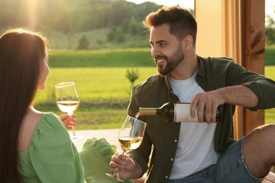 Photo of Romantic date. Beautiful couple with wine outdoors on sunny day