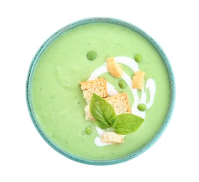 Photo of Green pea soup with croutons in bowl on white background, top view