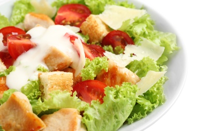 Delicious fresh Caesar salad in bowl on white background, closeup