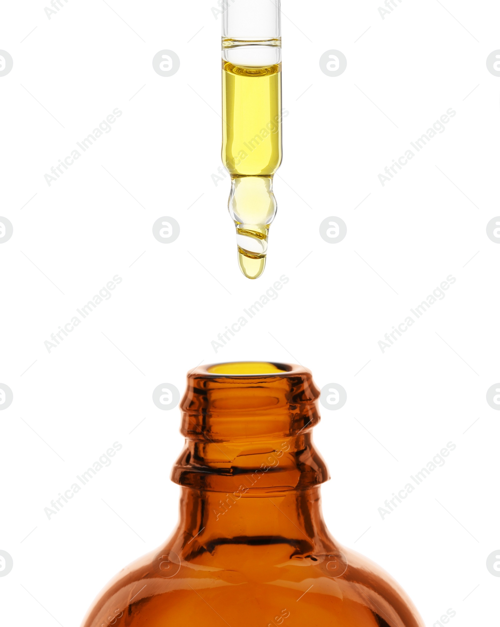 Photo of Dripping tincture from pipette into bottle isolated on white